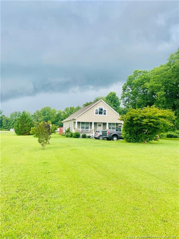 9167 Deep Branch Road Pembroke, NC 28372 - Photo 6 of 24 a front view of a house with a yard