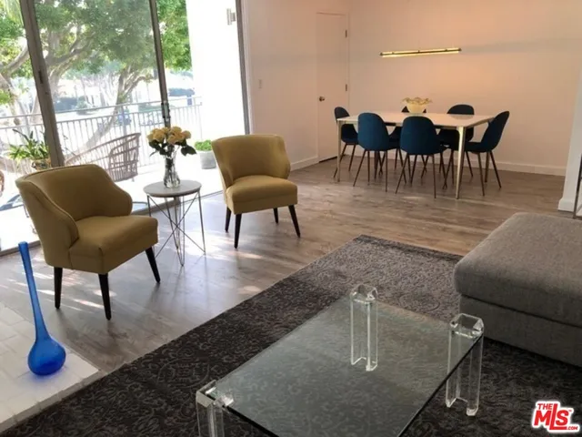 a kitchen with stainless steel appliances kitchen island granite countertop a sink stove and refrigerator