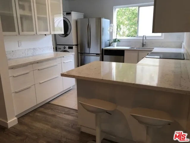 a large bed sitting in a bedroom next to a lamp