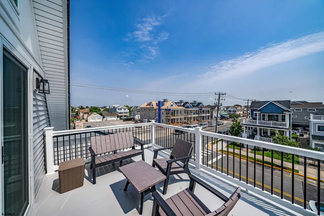 a view of a balcony with wooden chairs