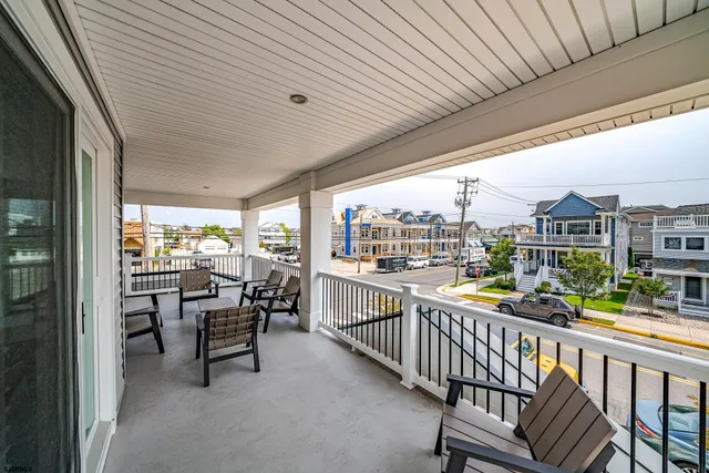 a view of a chairs and table in patio with potted plants