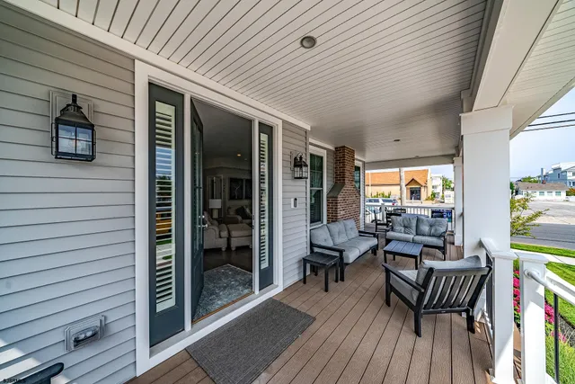 a view of a patio with table and chairs and floor to ceiling window with wooden floor