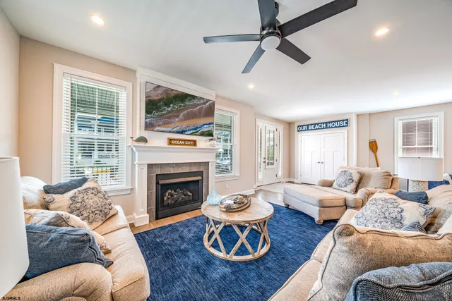 a living room with furniture fireplace and a large window
