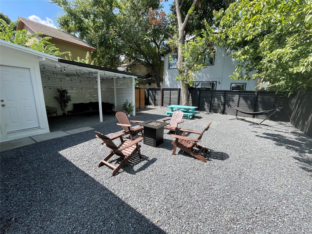 2402 Santa Rita Street Austin, TX 78702 - Photo 16 of 17 View of yard with a fire pit and a patio area before the cowboy pool.