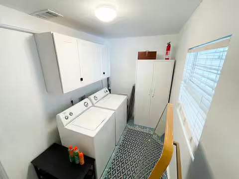 2402 Santa Rita Street Austin, TX 78702 - Photo 17 of 17 Laundry area featuring cabinet space and independent washer and dryer