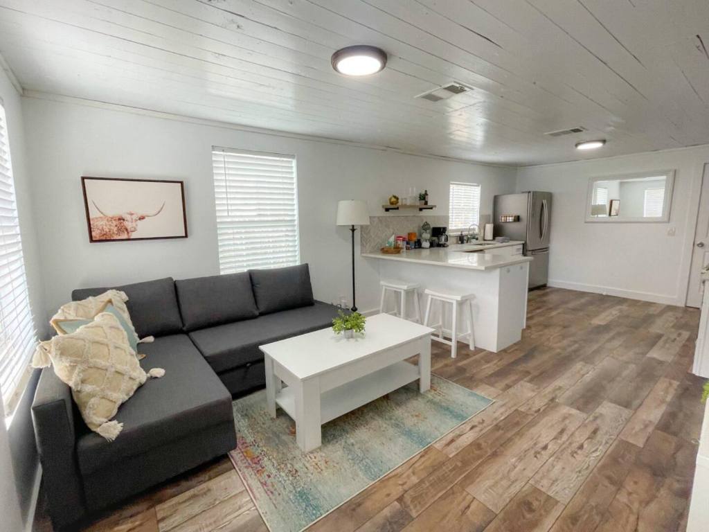 2402 Santa Rita Street Austin, TX 78702 - Photo 5 of 17 Living area with light wood-style floors and wooden ceiling