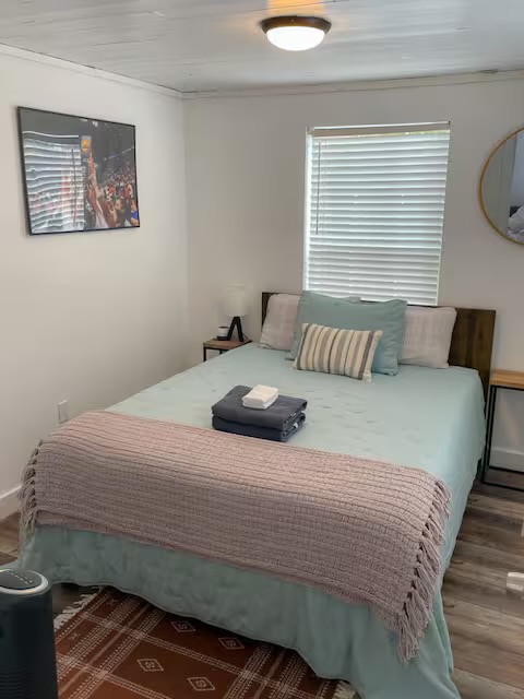 2402 Santa Rita Street Austin, TX 78702 - Photo 8 of 17 Bedroom with wood finished floors and ornamental molding