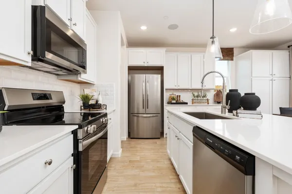 a kitchen with stainless steel appliances a sink microwave and stove