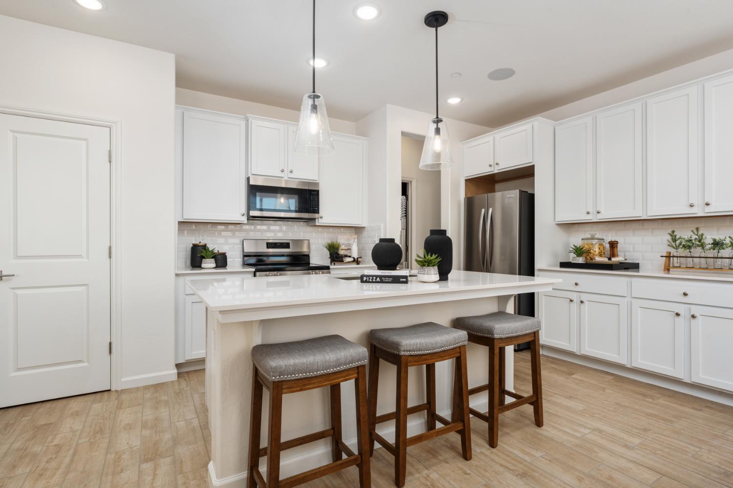 1472 Redbrick Lane Clovis, CA 93619 - Photo 9 of 33 a kitchen with stainless steel appliances granite countertop a sink a stove a refrigerator and island with wooden floor