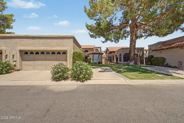 a view of a house with a yard and garage