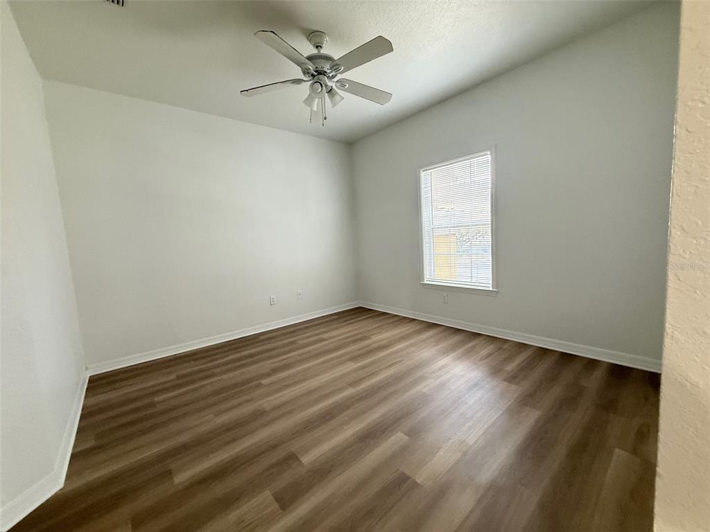 3611 Conroy Road, Unit 825 Orlando, FL 32839 - Photo 8 of 27 an empty room with wooden floor and windows