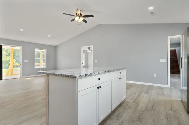 a bathroom with a granite countertop sink a mirror and vanity