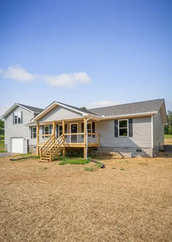 a backyard of a house with yard fire pit and outdoor seating