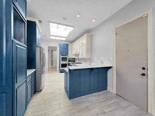 a kitchen with stainless steel appliances granite countertop a sink and cabinets