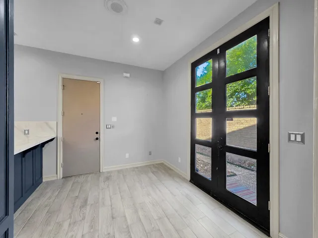 a view of a house with a wooden fence