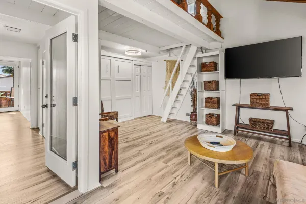 a view of a livingroom with furniture and staircase