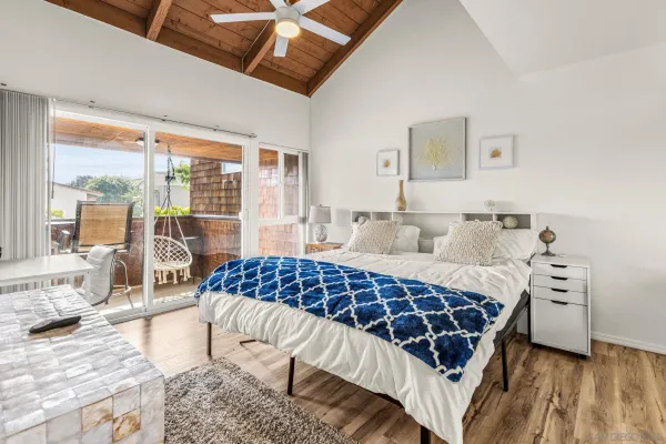 a bedroom with a bed and a desk