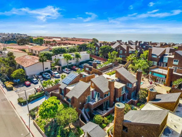 a view of a patio with furniture and a garden