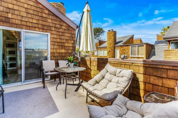 a view of a patio with couches table and chairs and potted plants