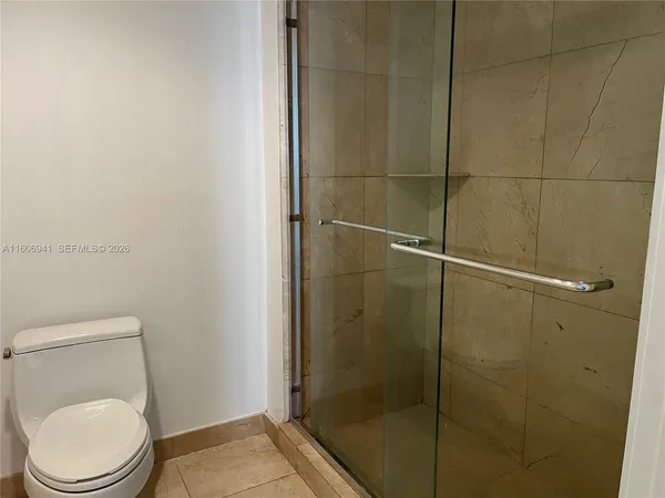 a bathroom with a toilet and a shower