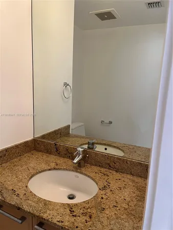a bathroom with a sink and vanity