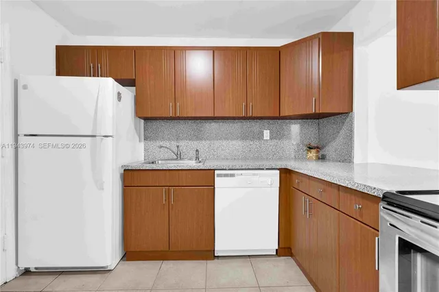 a white refrigerator freezer sitting in a kitchen