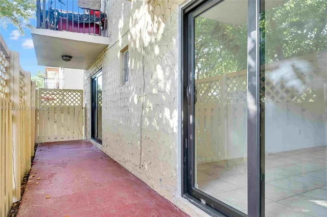 a view of a hallway with a glass door and shower