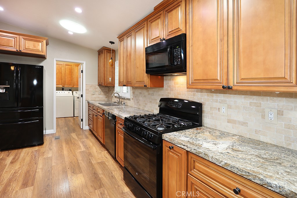 61 Saddleback Road Tustin, CA 92780 - Photo 11 of 49 a kitchen with stainless steel appliances granite countertop a stove a sink and a microwave