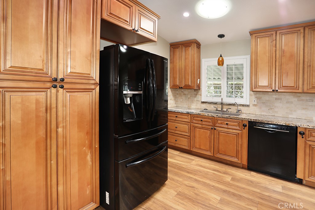 61 Saddleback Road Tustin, CA 92780 - Photo 14 of 49 a kitchen with a refrigerator and cabinets