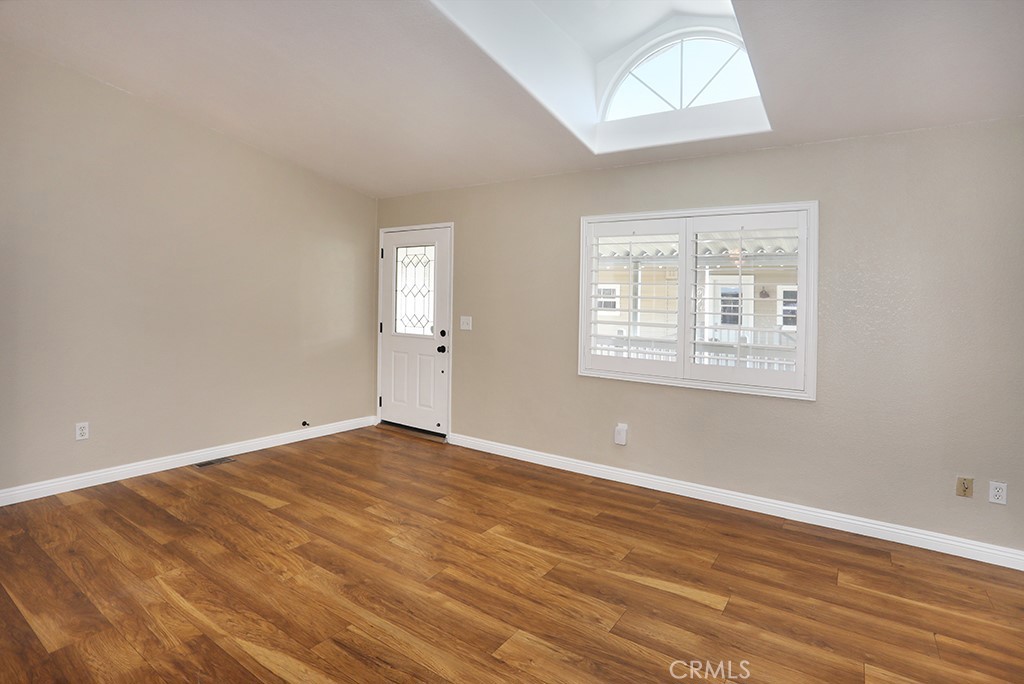 61 Saddleback Road Tustin, CA 92780 - Photo 16 of 49 an empty room with wooden floor and windows