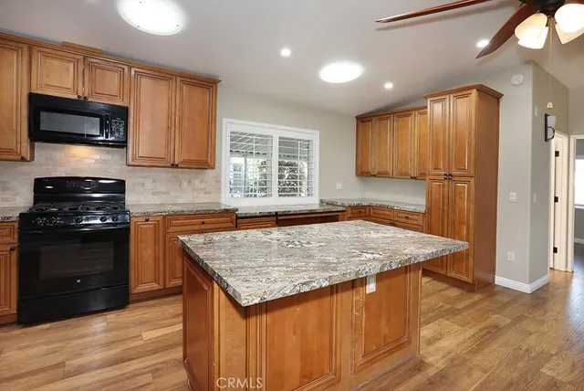 a kitchen with a refrigerator and cabinets