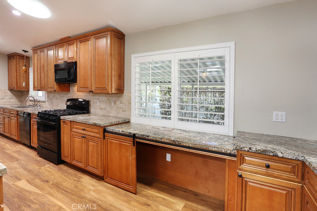 61 Saddleback Road Tustin, CA 92780 - Photo 9 of 49 a kitchen with granite countertop a sink and a stove top oven