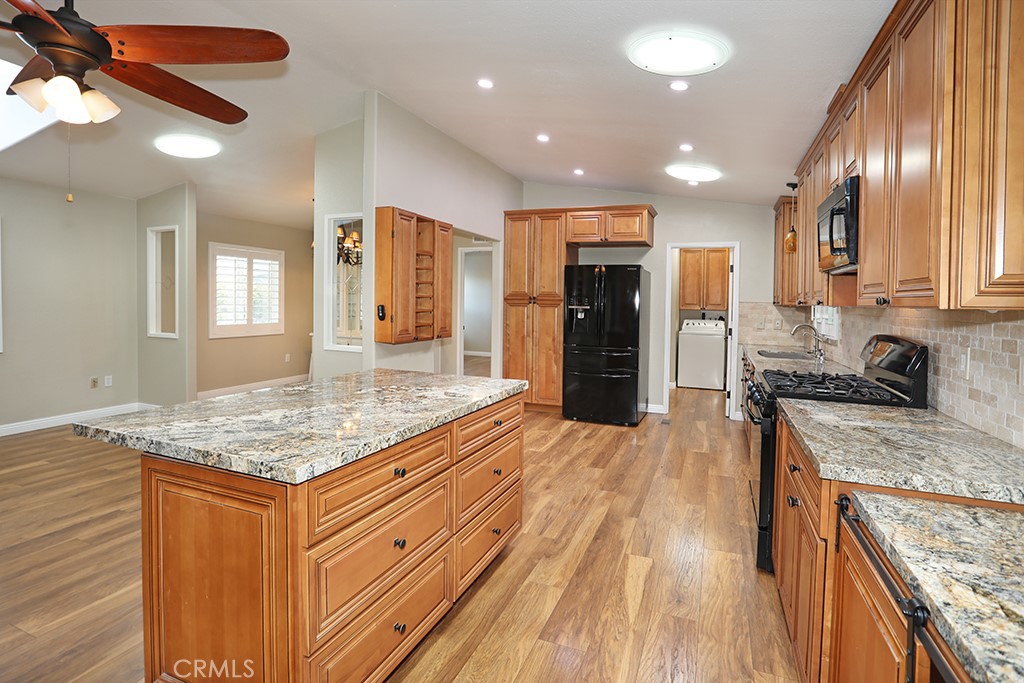 61 Saddleback Road Tustin, CA 92780 - Photo 10 of 49 a kitchen with stainless steel appliances granite countertop a sink stove and refrigerator