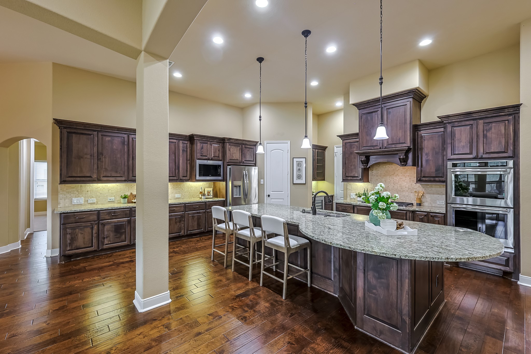 515 Mill Creek Road Pinehurst, TX 77362 - Photo 17 of 48 This spacious kitchen features elegant dark wood cabinetry, granite countertops, and a large center island with seating.