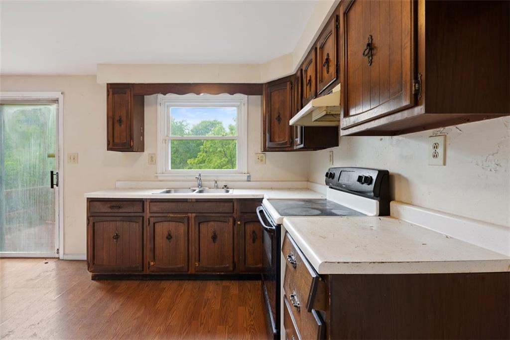 724 Camp Meeting Road Sewickley, PA 15143 - Photo 17 of 32 a kitchen with a sink a window and cabinets