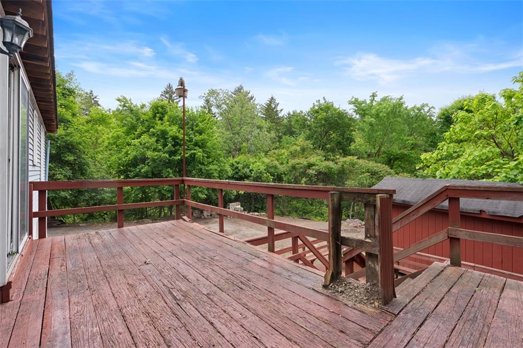 724 Camp Meeting Road Sewickley, PA 15143 - Photo 21 of 32 a view of deck with furniture and trees in the background