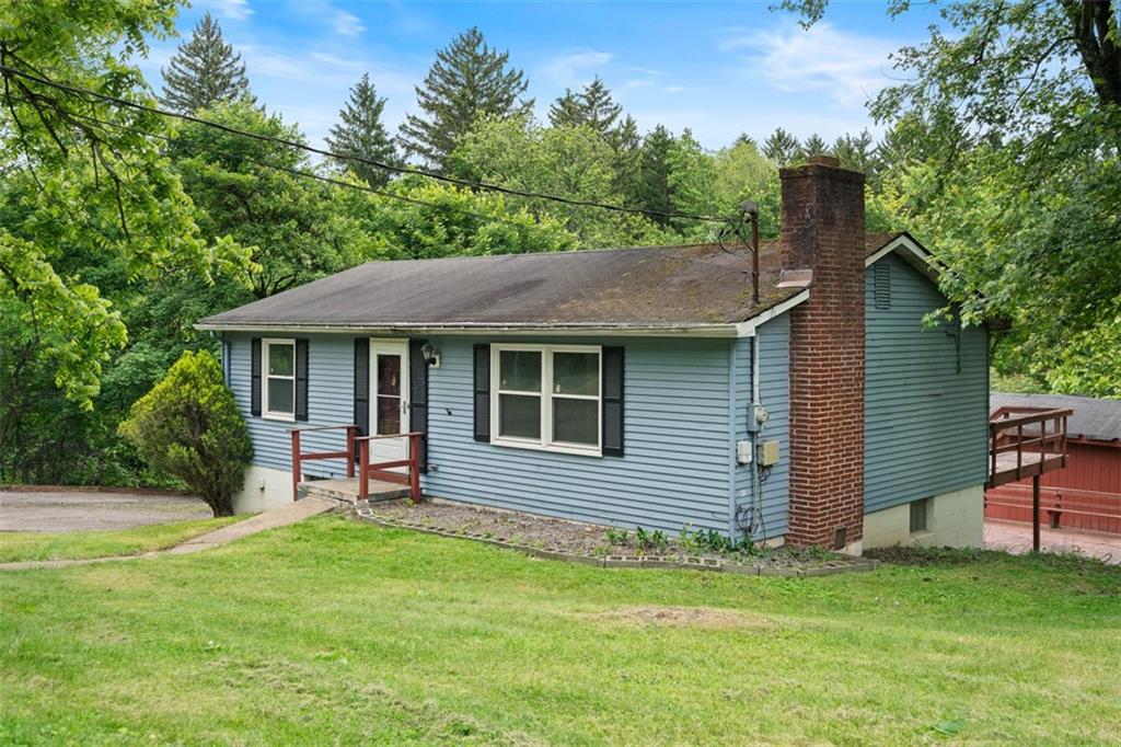724 Camp Meeting Road Sewickley, PA 15143 - Photo 5 of 32 a backyard of a house with table and chairs floor to ceiling window and wooden fence
