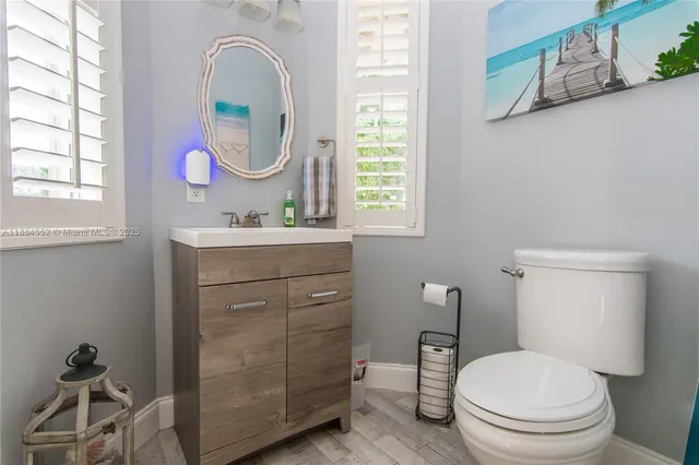 a bathroom with a toilet a sink and a mirror