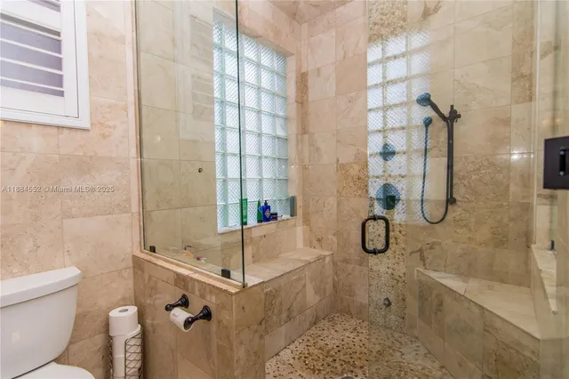 a spacious bathroom with a double vanity sink a mirror and a bathtub