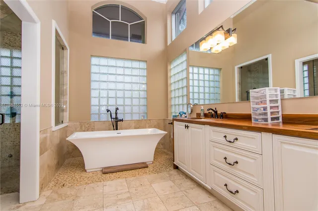 a spacious bathroom with a tub sink and shower