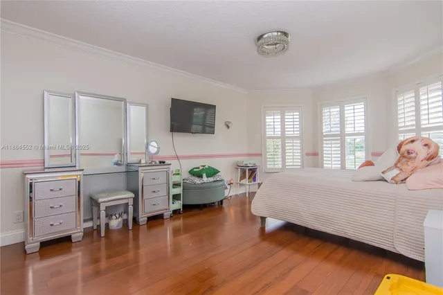 a bedroom with bed and wooden floor