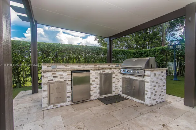 a view of a patio with chairs and table with garden view