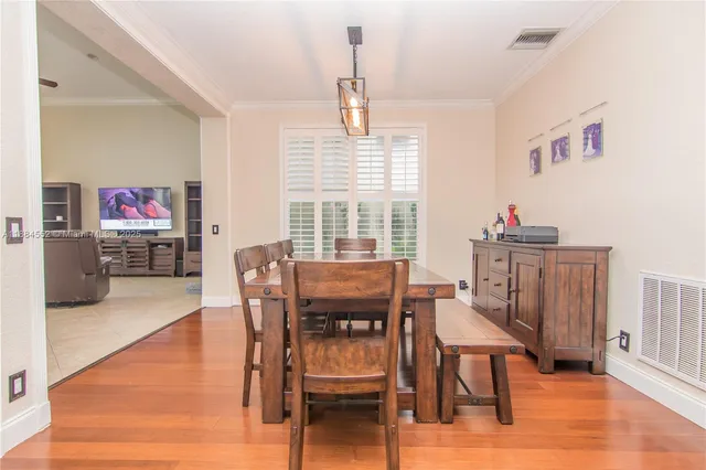 a dining room with furniture and wooden floor
