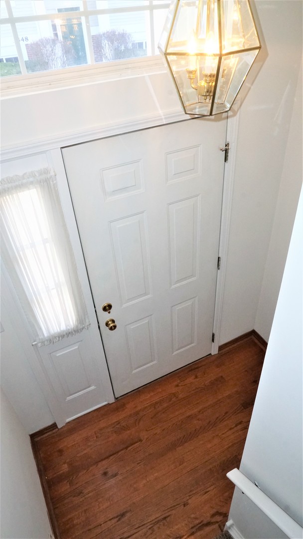 3360 Ravinia Circle Aurora, IL 60504 - Photo 2 of 32 a view of a room with wooden floor and white walls