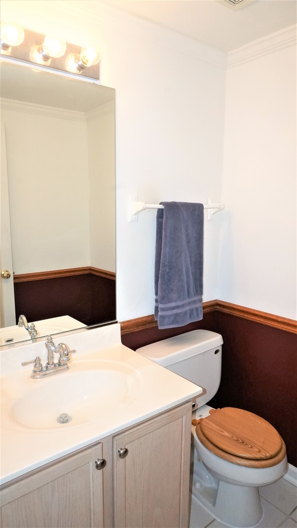 3360 Ravinia Circle Aurora, IL 60504 - Photo 11 of 32 a bathroom with a sink a toilet and mirror