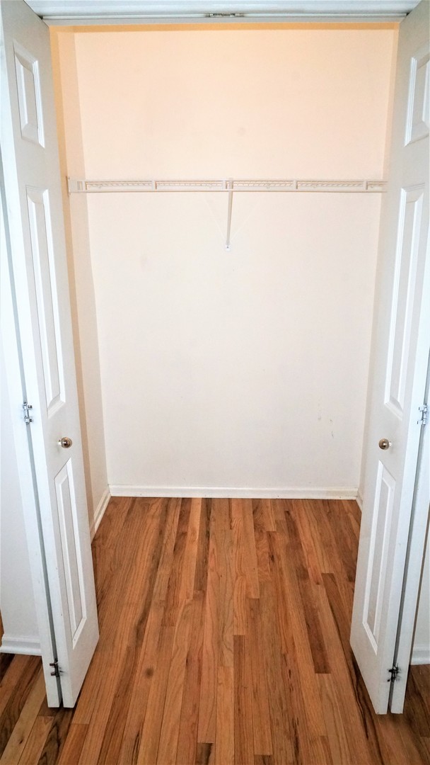 3360 Ravinia Circle Aurora, IL 60504 - Photo 12 of 32 a view of a room with wooden floor and bench