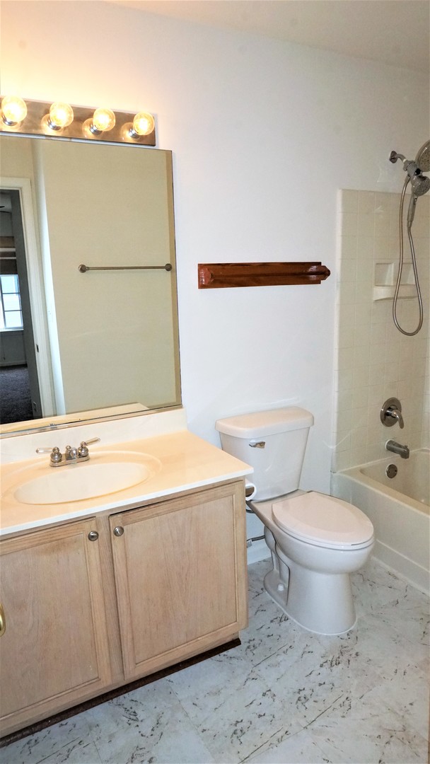 3360 Ravinia Circle Aurora, IL 60504 - Photo 16 of 32 a bathroom with a sink toilet and shower