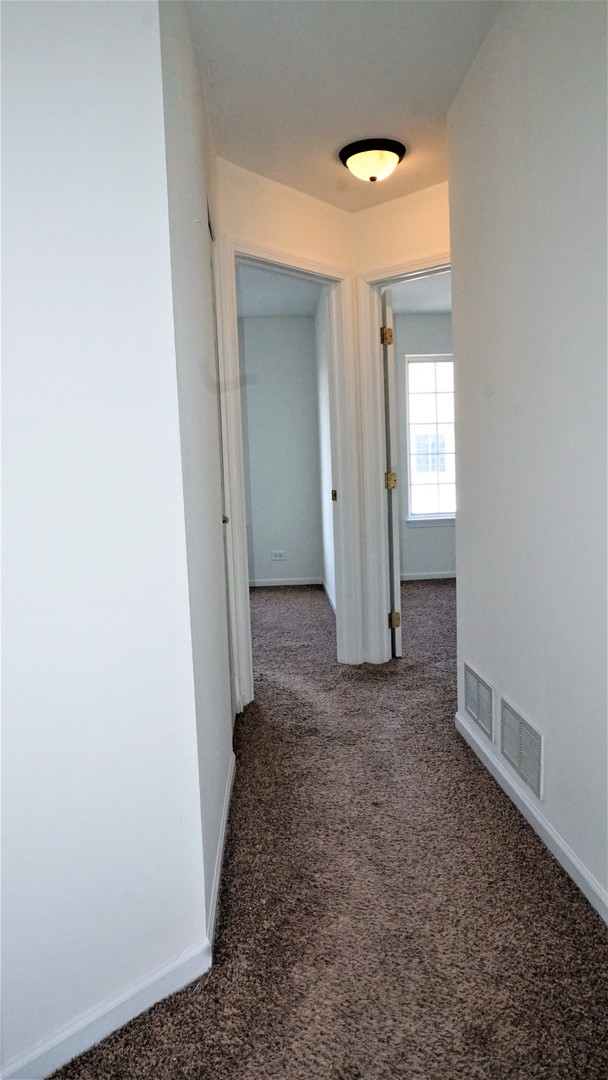 3360 Ravinia Circle Aurora, IL 60504 - Photo 18 of 32 an empty room with windows and closet