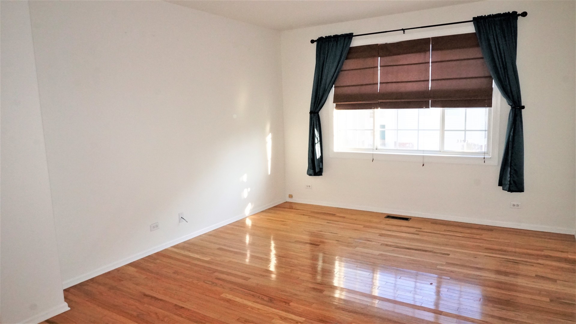 3360 Ravinia Circle Aurora, IL 60504 - Photo 4 of 32 a view of empty room with wooden floor and fan