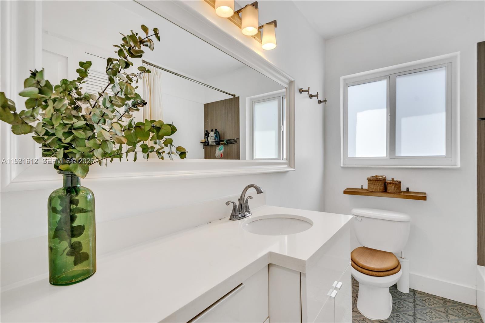 419 Southwest 30th Road Miami, FL 33129 - Photo 13 of 22 a bathroom with a sink a toilet and mirror